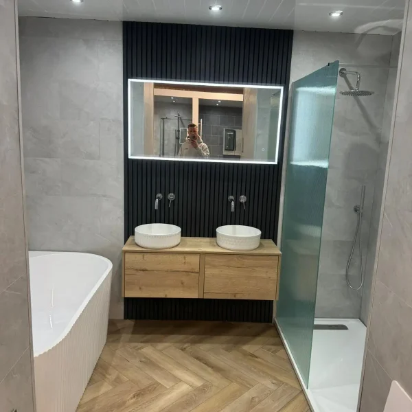 Wet room transformation with walk-in glass shower screen and porcelain tiling